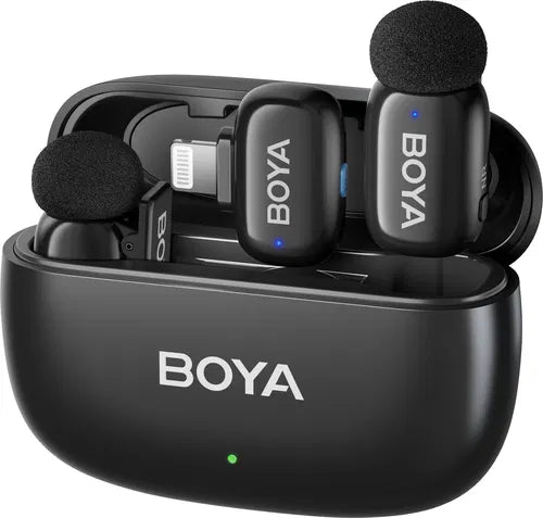Close-up of BOYA Mini 15 compact wireless microphone transmitters inside portable charging case