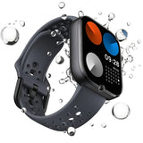 Xiaomi Redmi Watch 4 smartwatch with a dark grey perforated sports strap and water droplets splashing around the screen.